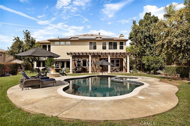 view of pool featuring an in ground hot tub, a yard, and a patio