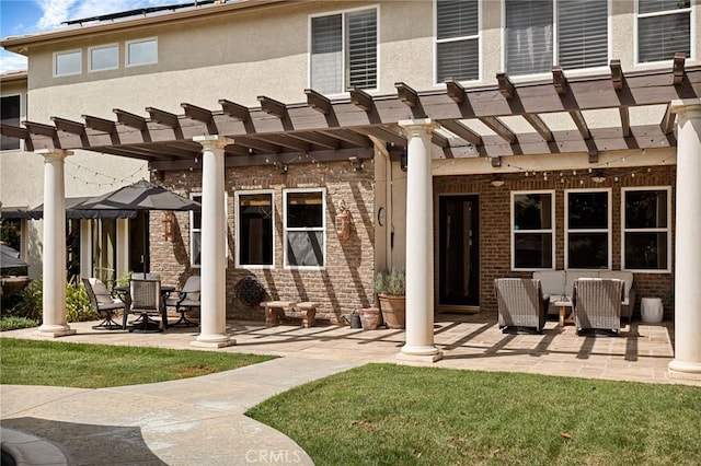 rear view of property with a patio, a lawn, and a pergola