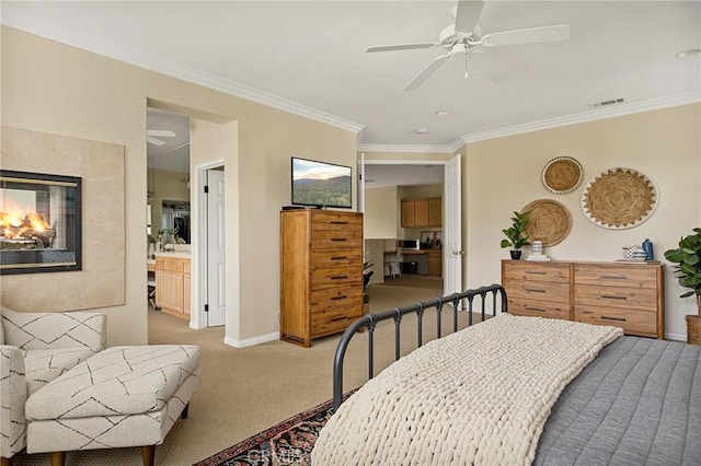 carpeted bedroom with ceiling fan, ensuite bath, and crown molding