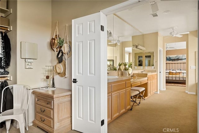 bathroom with ceiling fan and vanity