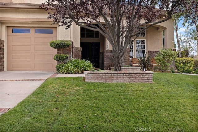 view of front facade with a garage and a front lawn