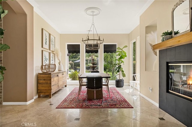 interior space featuring a healthy amount of sunlight, a fireplace, crown molding, and a notable chandelier