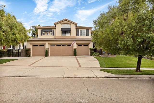 view of front of property featuring a garage and a front lawn