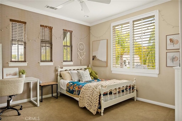 carpeted bedroom featuring ceiling fan and crown molding