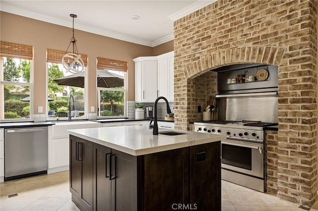 kitchen featuring pendant lighting, stainless steel appliances, sink, backsplash, and dark brown cabinets