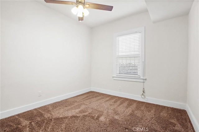 carpeted spare room featuring ceiling fan