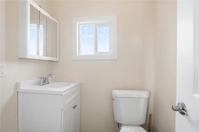 bathroom with toilet and vanity