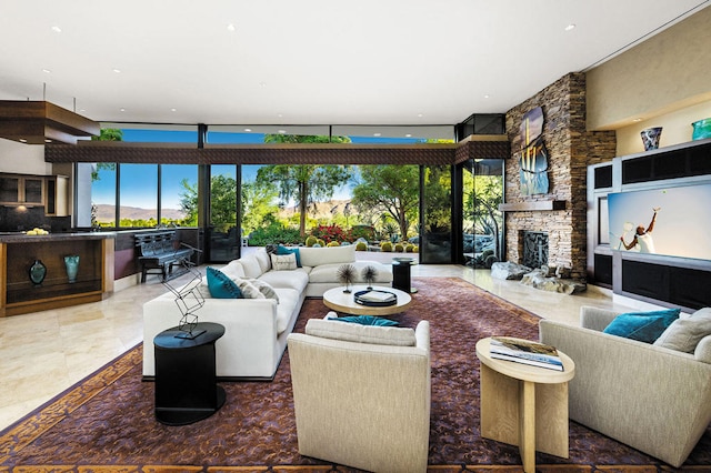 living room with a stone fireplace