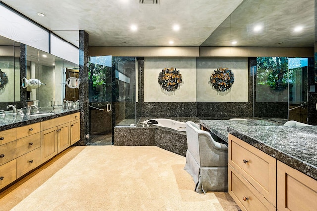 bathroom with vanity, tile walls, and shower with separate bathtub