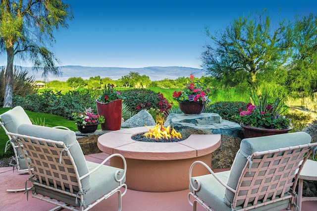 view of patio featuring a mountain view and an outdoor fire pit