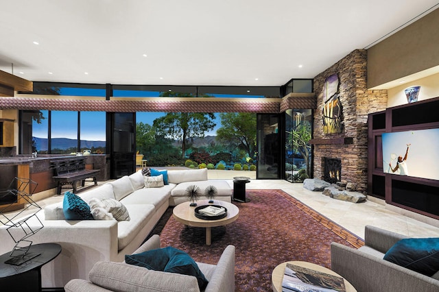 living room with a stone fireplace