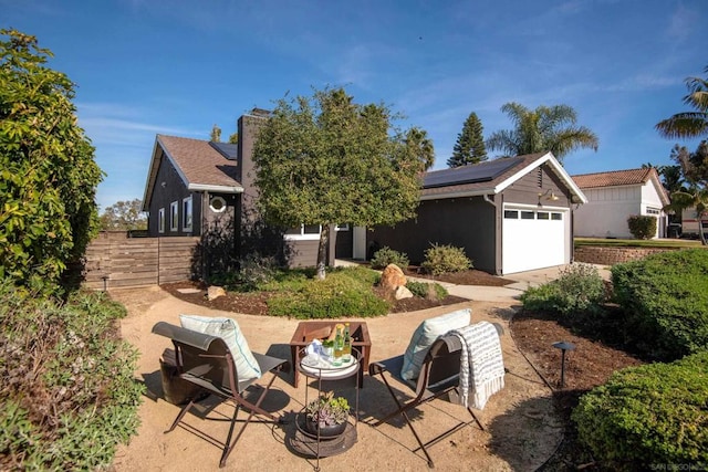 view of front of house featuring solar panels and a garage