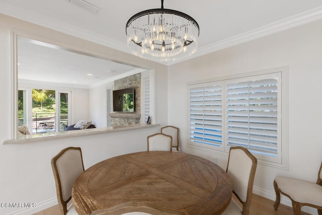 dining area featuring hardwood / wood-style flooring, crown molding, and an inviting chandelier