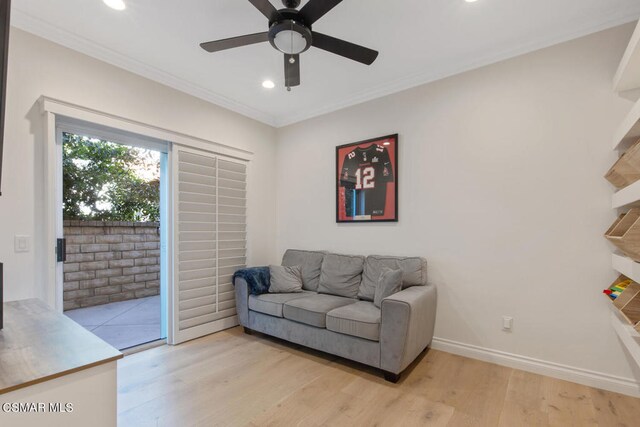 living room with ceiling fan, light hardwood / wood-style flooring, and crown molding