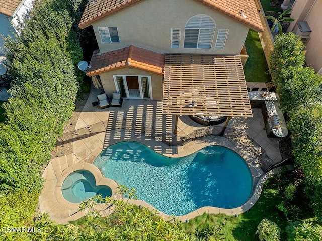 view of pool featuring an in ground hot tub and a patio