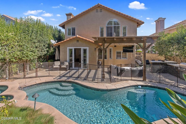 rear view of property featuring a patio area, a fenced in pool, and a pergola