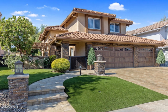 mediterranean / spanish house featuring a front lawn and a garage