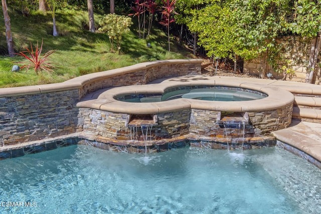 view of swimming pool featuring an in ground hot tub and pool water feature