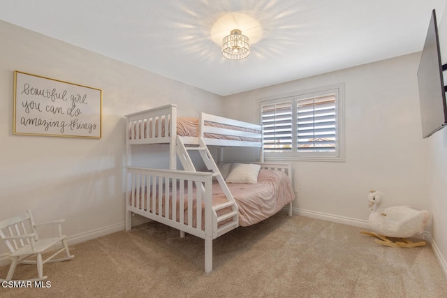 carpeted bedroom with a notable chandelier