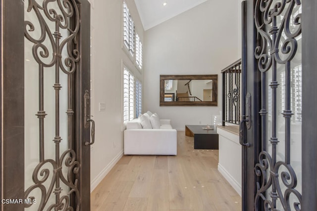 entrance foyer with light hardwood / wood-style floors and lofted ceiling