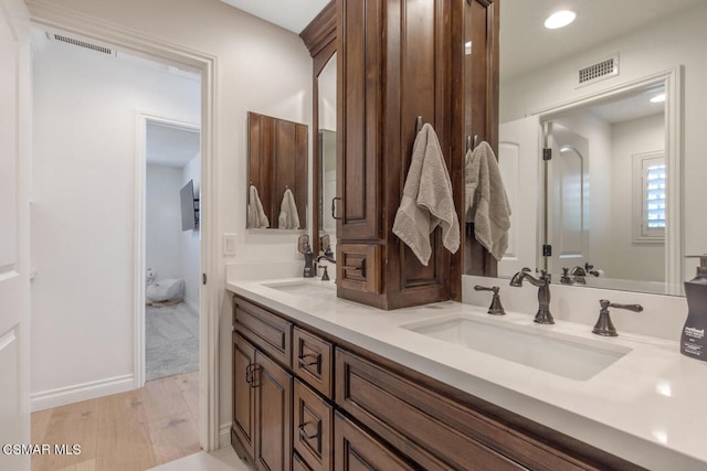 bathroom featuring vanity and hardwood / wood-style floors