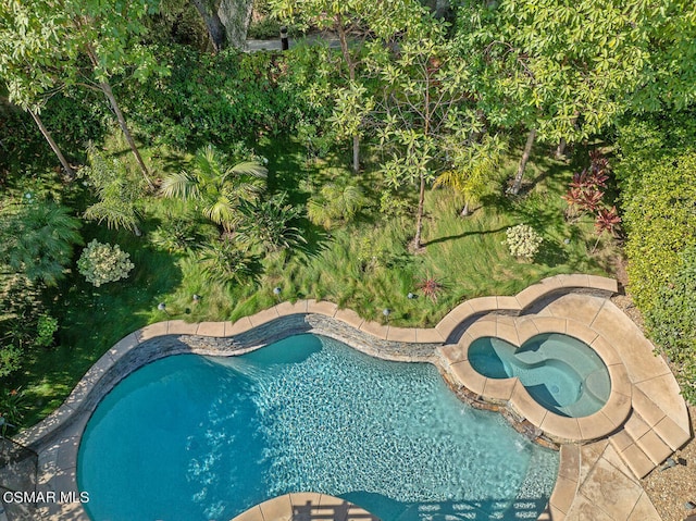 view of pool featuring an in ground hot tub