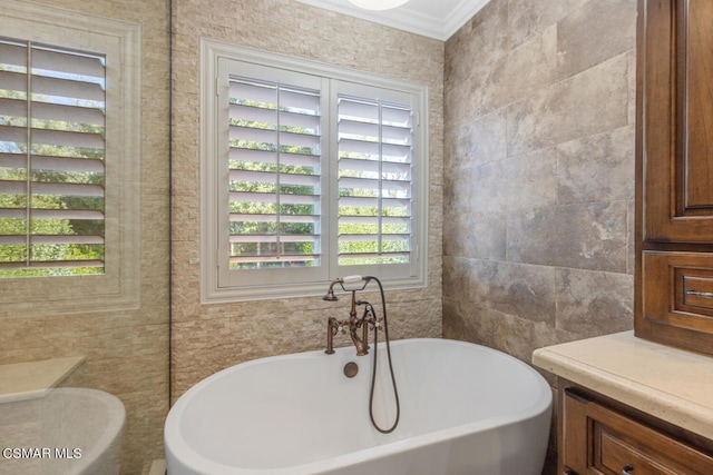 bathroom featuring tile walls, crown molding, and a bathing tub