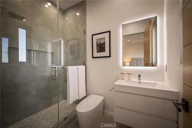 bathroom with vanity, an enclosed shower, and toilet