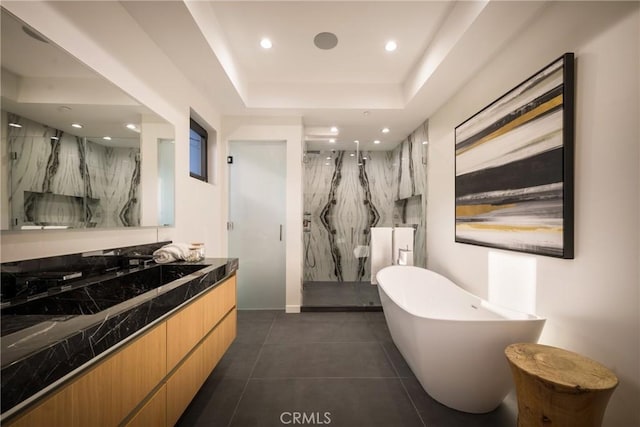 bathroom with vanity, tile patterned flooring, a tray ceiling, and plus walk in shower