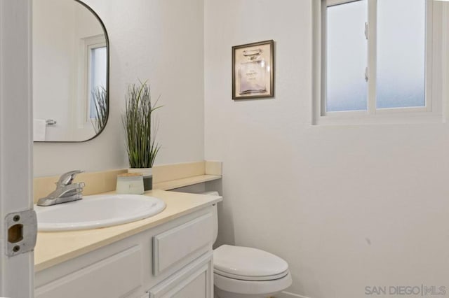 bathroom with toilet and vanity