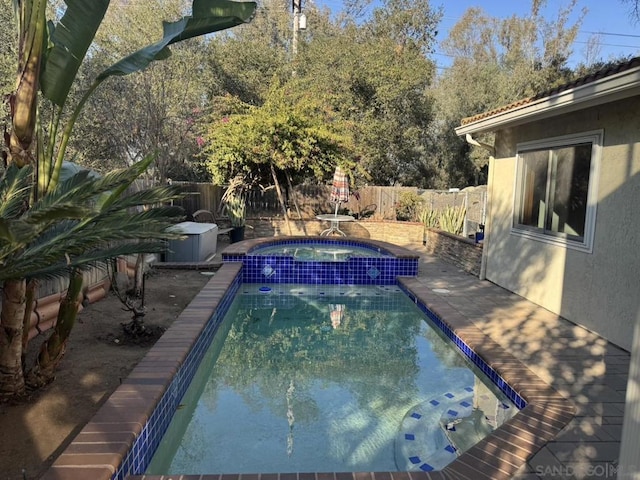 view of swimming pool featuring an in ground hot tub