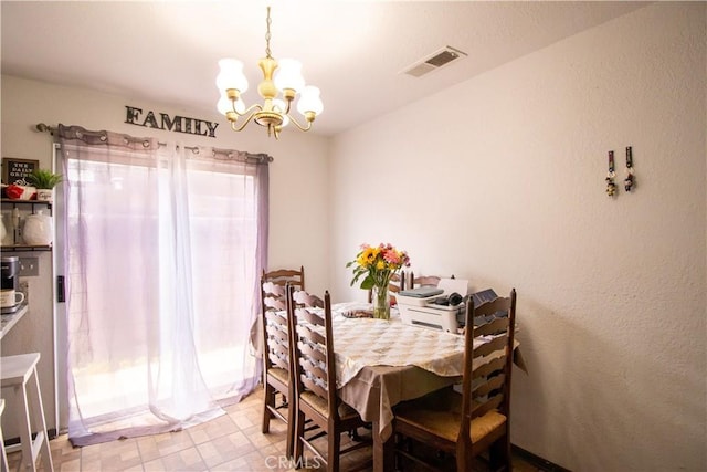 dining space with a chandelier