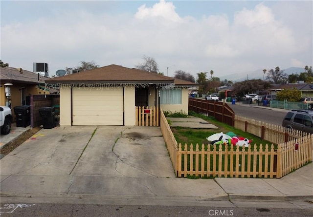 view of front of home with central AC unit and a garage