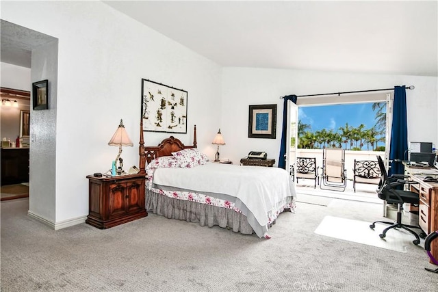 carpeted bedroom featuring ensuite bathroom and lofted ceiling