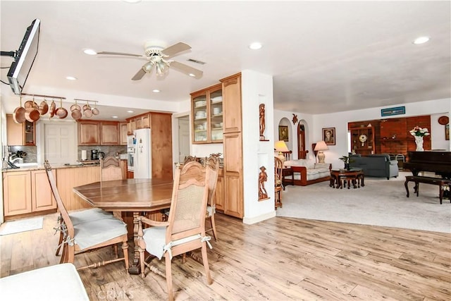 dining space featuring ceiling fan and light hardwood / wood-style floors