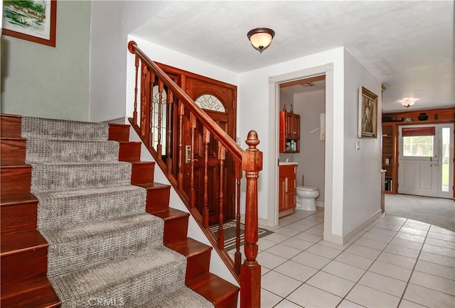 stairway with tile patterned floors