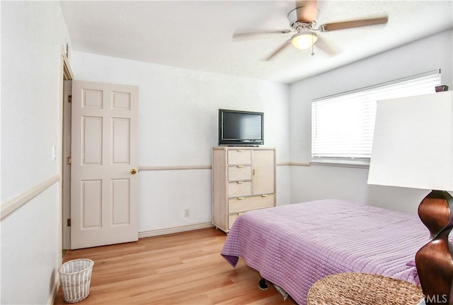 bedroom with ceiling fan and light hardwood / wood-style flooring