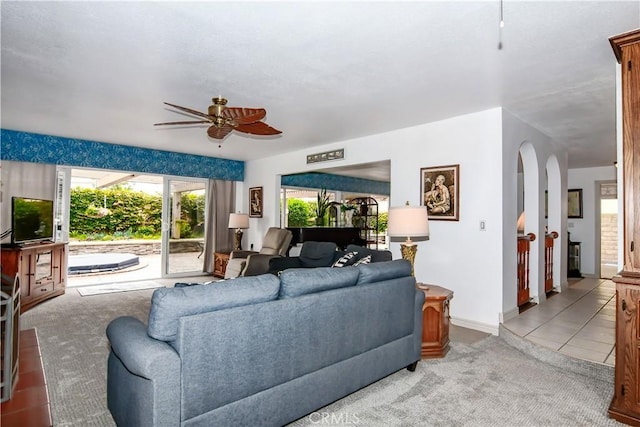 carpeted living room featuring ceiling fan