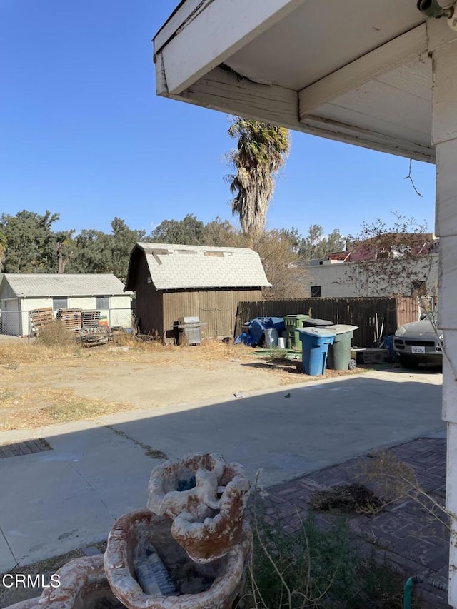 view of patio featuring a storage unit