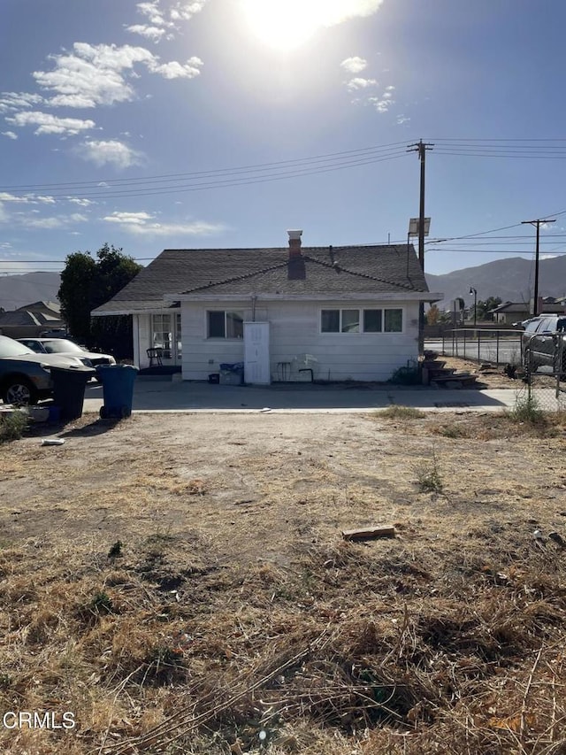 rear view of property featuring a patio area and a mountain view