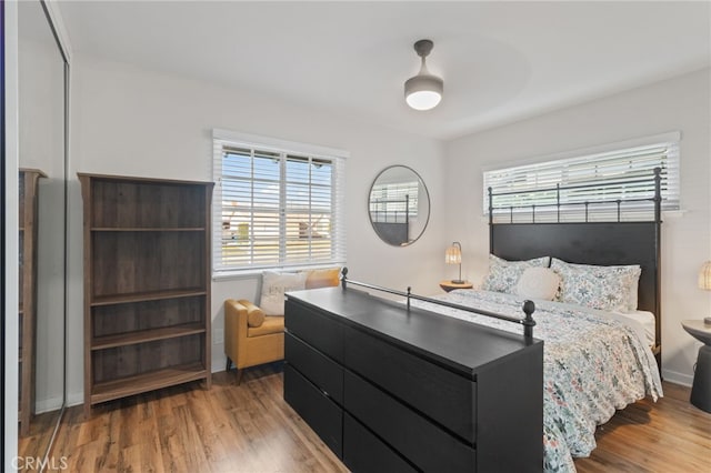 bedroom with wood-type flooring and ceiling fan