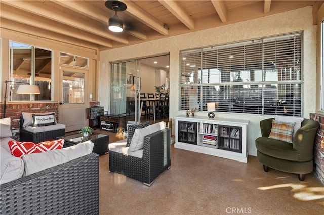 interior space with an outdoor living space and ceiling fan