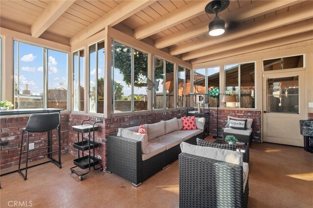 sunroom featuring beam ceiling