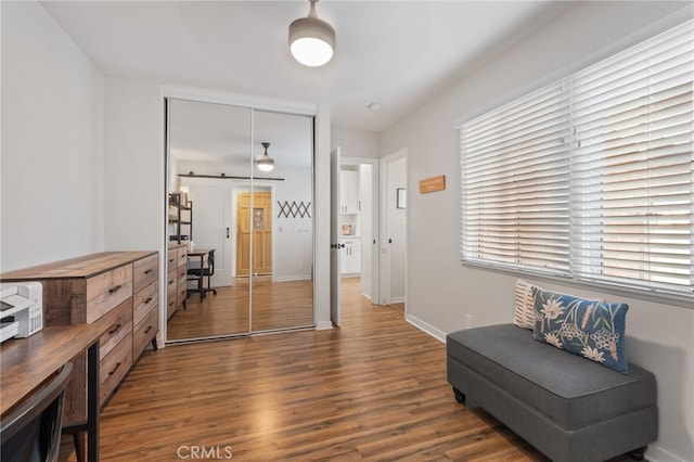 sitting room with dark wood-type flooring