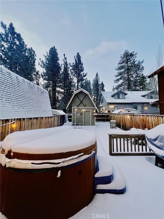 snowy yard featuring a hot tub