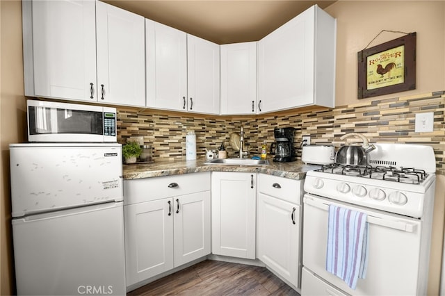 kitchen with sink, white appliances, decorative backsplash, and white cabinets