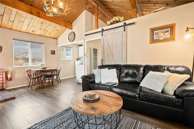 living room with wood ceiling, dark hardwood / wood-style flooring, washer / clothes dryer, a barn door, and beamed ceiling