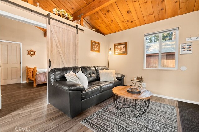 living room with wood ceiling, a barn door, lofted ceiling with beams, and hardwood / wood-style floors