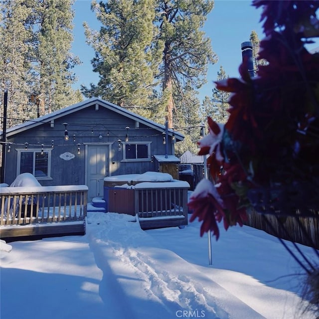 view of front of home featuring a wooden deck and a hot tub