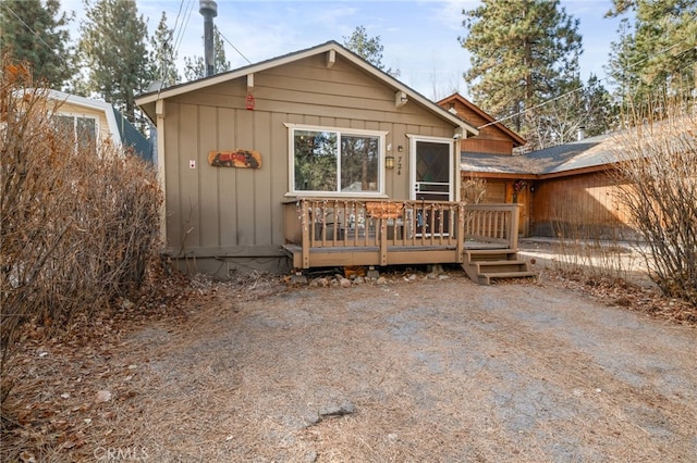 rear view of house featuring a deck